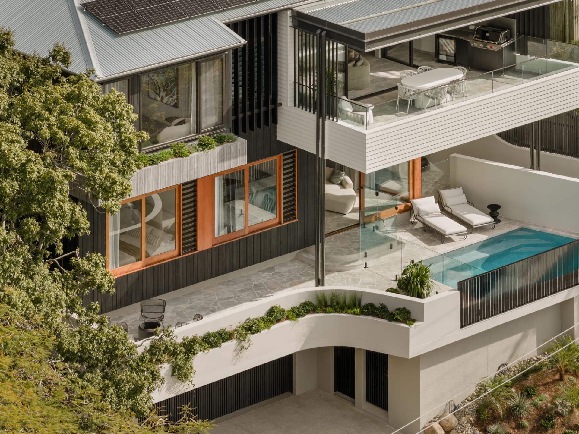 Aerial view of the pool terrace and layered living levels