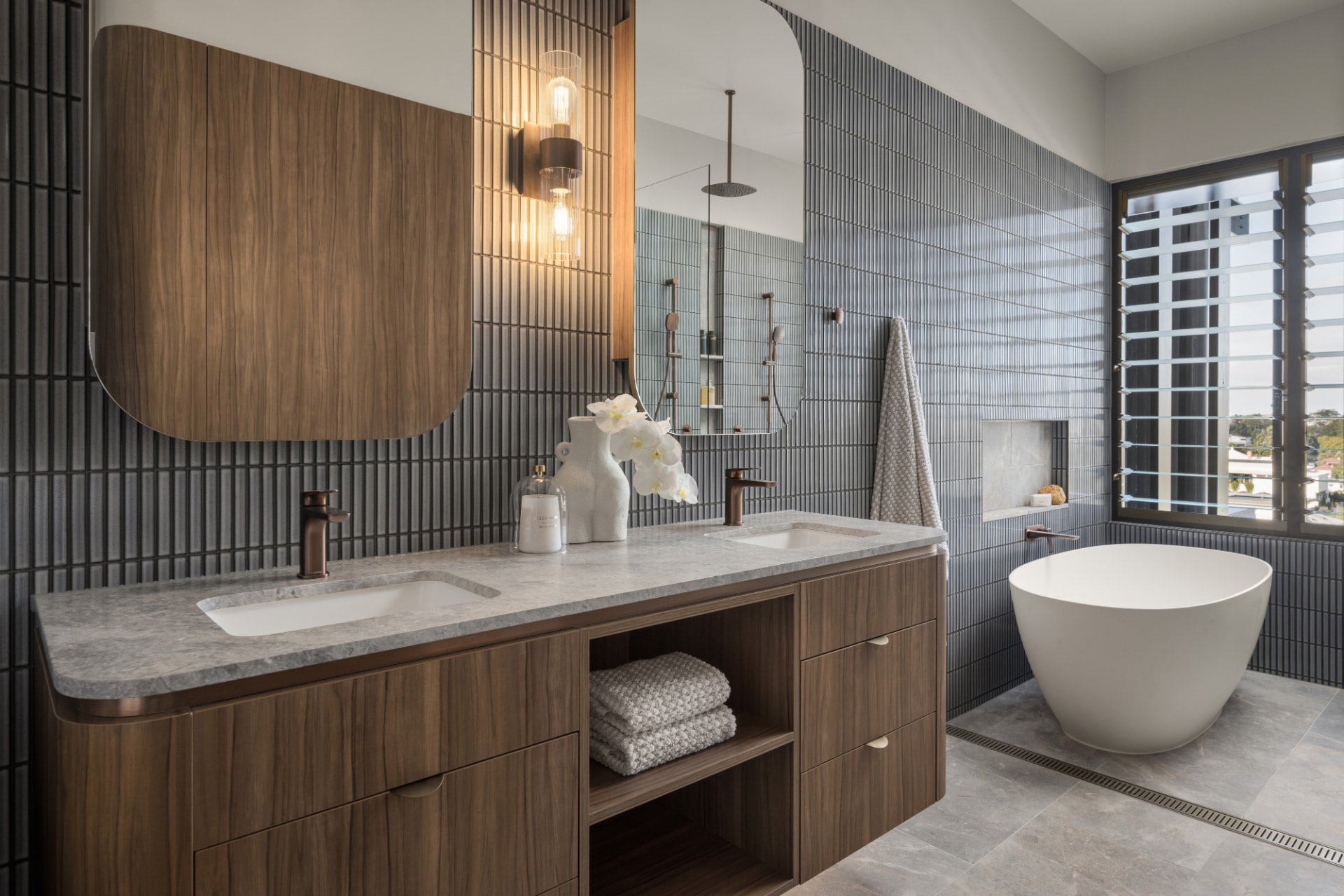 The same ensuite seen from the vanity, twin basins and fluted tiling