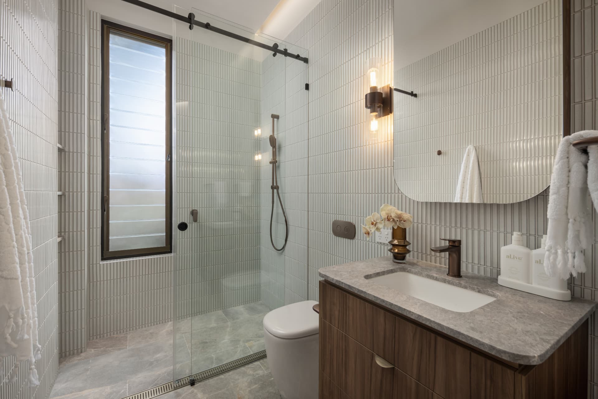 Secondary bathroom with fluted tiling and timber vanity