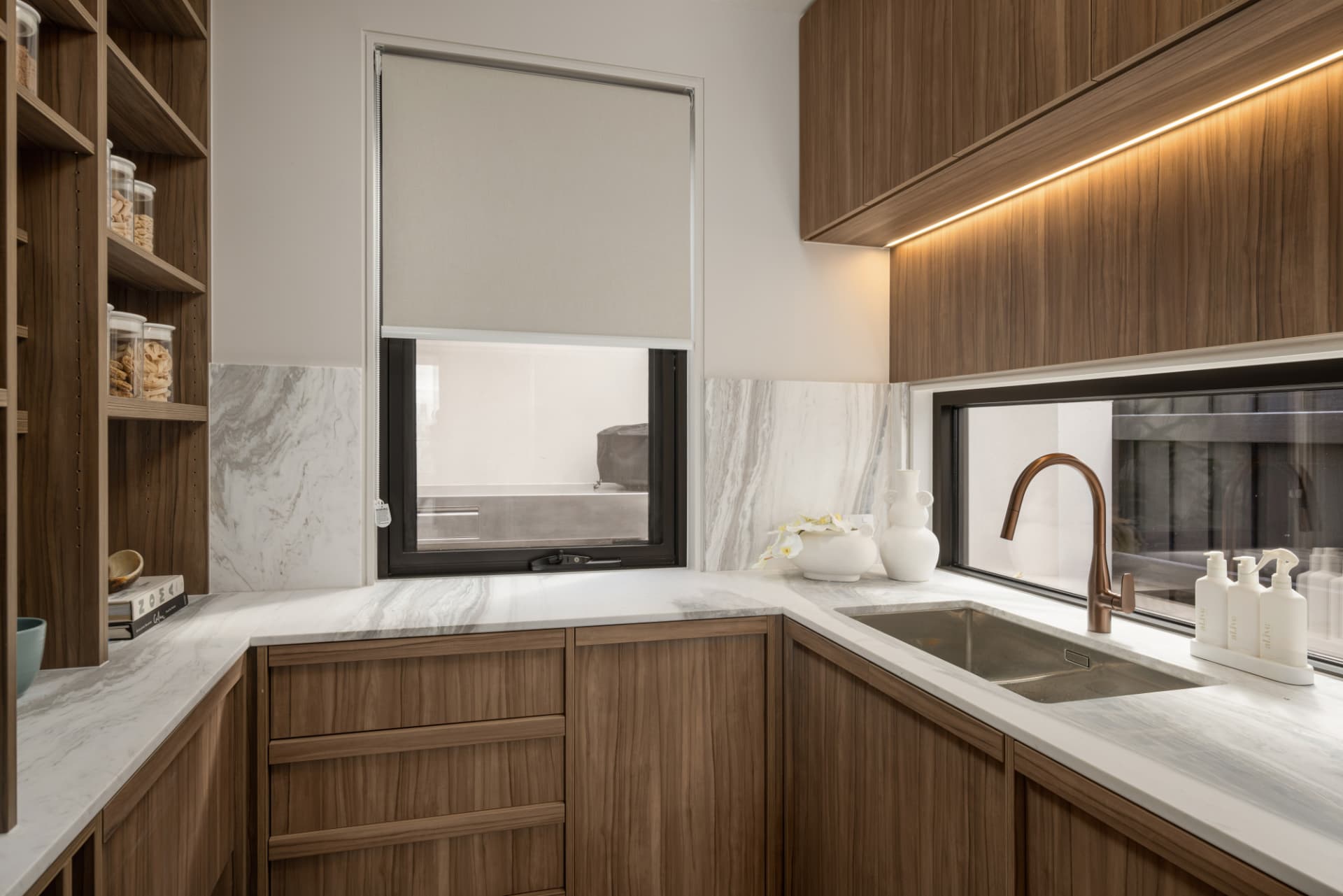 Butler's pantry with walnut joinery and marble benchtops