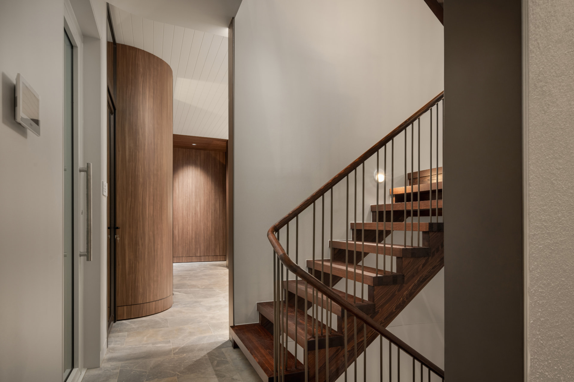 Timber stair and curved walnut joinery in the entry hall